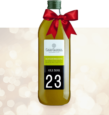 Novello olive oil wrapped in bow with festive background.